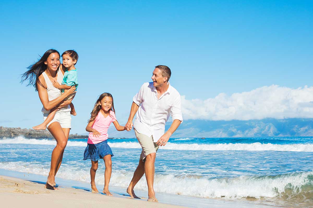 family-running-together-on-the-beach Family running together on a sunny beach